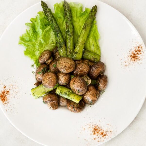 Fried garlic mushrooms and asparagus, prepared fresh at Pierogi Bar St Pete.