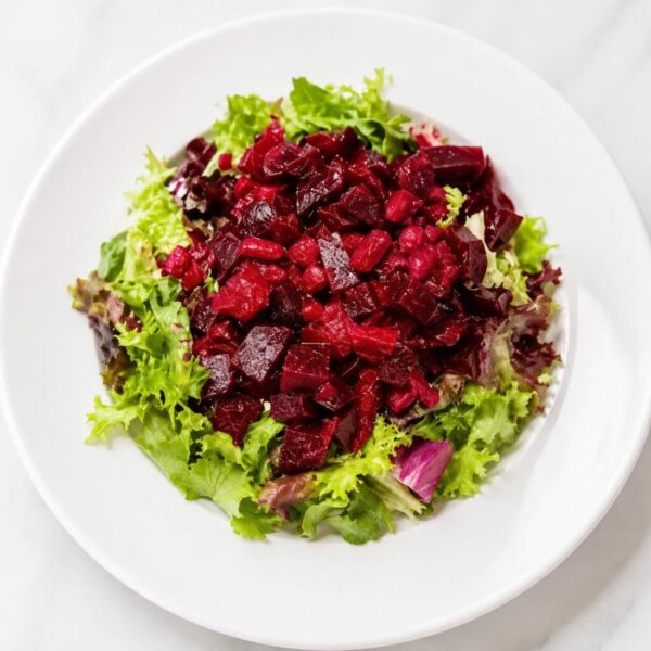 Traditional Hutsul Varya salad with red beets, sauerkraut, dried cranberries, onion, and cold-pressed sunflower oil.