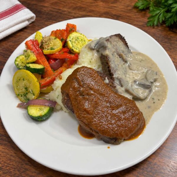 Ukrainian-inspired meatloaf with mashed potatoes, seasonal vegetables, red wine onion ragout, and mushroom gravy.